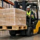 Forklift lifting EPAL pallet safely in warehouse aisle