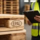 Worker inspecting EPAL pallet stamp in a warehouse before purchase