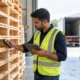 Questions to ask before buying pallets: a buyer inspects stacked wooden pallets